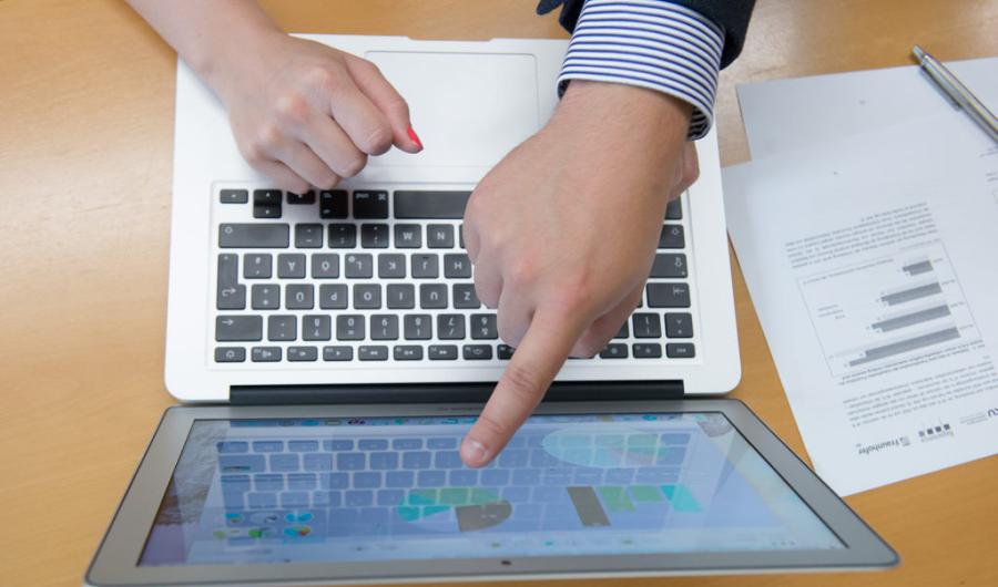 Innovation Camp Zwei Hände über einer Laptoptastatur - ein Finger zeigt zum Bildschirm